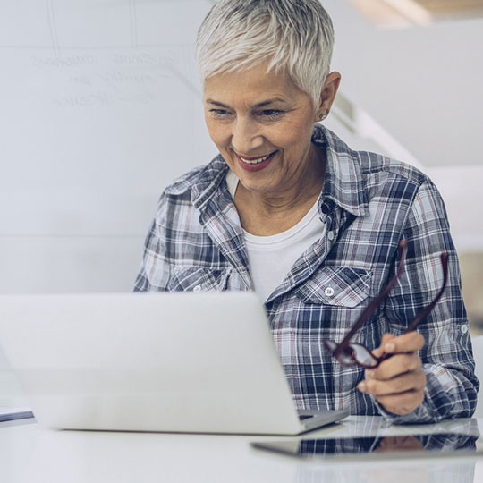 woman reading articles on laptop
