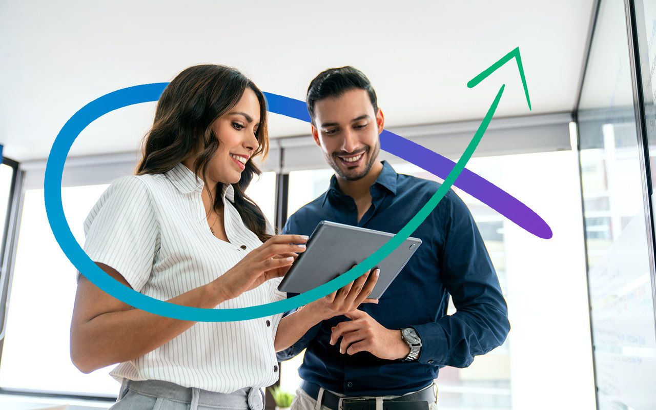 Latin American business people sharing ideas at the office while using a digital tablet - people at work concepts