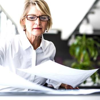 Business Content Management businesswoman sorting papers