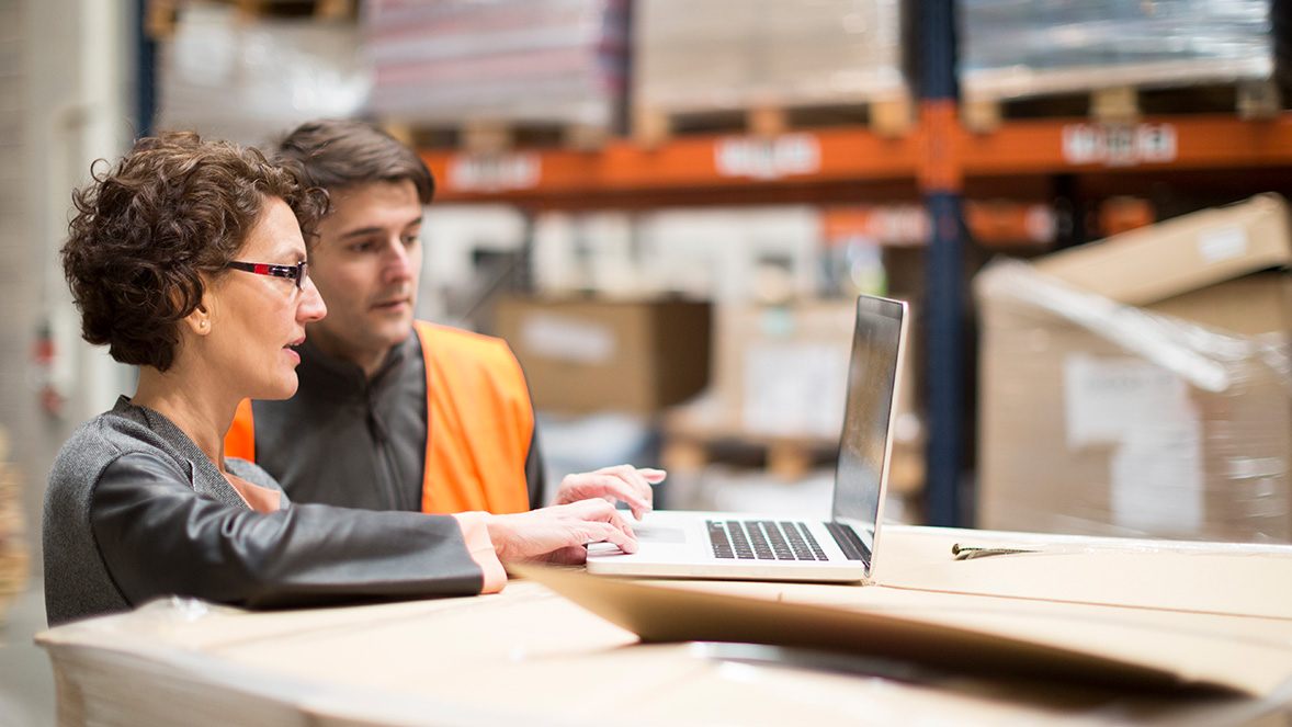 two colleagues working at a laptop two colleagues working at a laptop