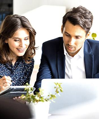 Razionalizzare le attività con terzi  two colleagues looking at a laptop